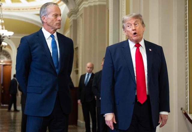 US President Donald Trump, alongside Senate Majority Leader John Thune, Republican from South Dakota, speaks to the press on the way to a lunch meeting with Senate Republicans at the US Capitol in Washington, DC, on June 24, 2026. President Trump said Wednesday he will refuse to sign a landmark housing bill, passed by Congress with broad bipartisan support, until lawmakers approve legislation that would overhaul American elections and restrict voter registration. (Photo by SAUL LOEB / AFP)