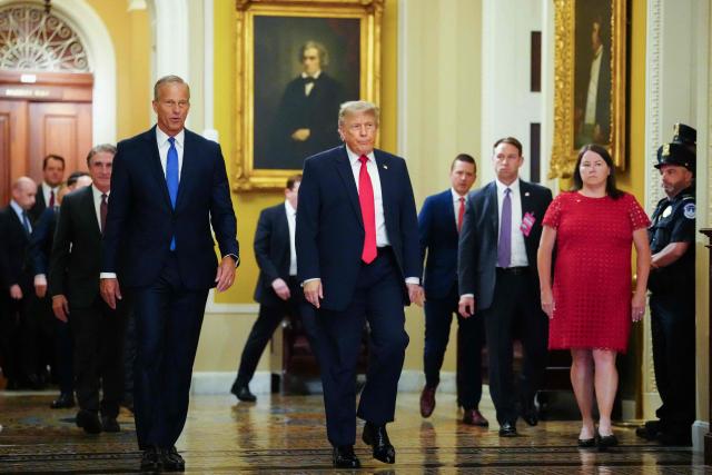 US President Donald Trump walks with Senate Majority Leader John Thune, Republican from South Dakota, on the way to a lunch meeting with Senate Republicans at the US Capitol in Washington, DC, on June 24, 2026. President Trump said Wednesday he will refuse to sign a landmark housing bill, passed by Congress with broad bipartisan support, until lawmakers approve legislation that would overhaul American elections and restrict voter registration. (Photo by Aaron Schwartz / AFP)