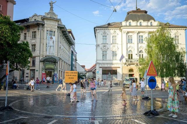 Pedestrians cool off at “The area with Ljubljana’s own weather” in Preseren Square in Ljubljana on June 24, 2026. Europe struggled to cope with a record-breaking heatwave on June 24, 2026, with at least 94 million people expected to experience temperatures above 35C, most of them in France and Spain. (Photo by Jure MAKOVEC / AFP)