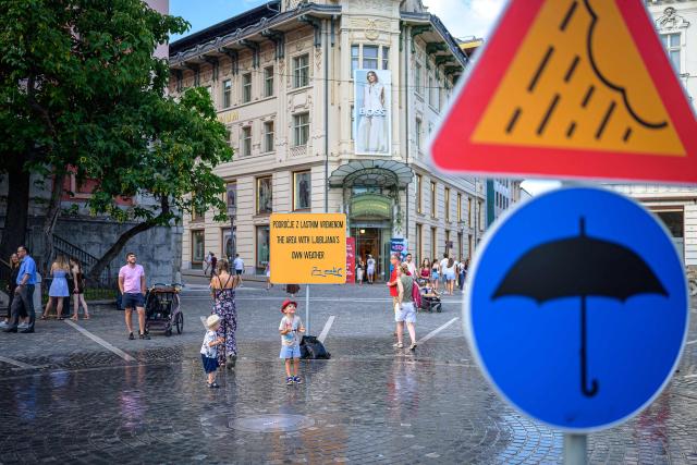 Pedestrians cool off at “The area with Ljubljana’s own weather” in Preseren Square in Ljubljana on June 24, 2026. Europe struggled to cope with a record-breaking heatwave on June 24, 2026, with at least 94 million people expected to experience temperatures above 35C, most of them in France and Spain. (Photo by Jure MAKOVEC / AFP)
