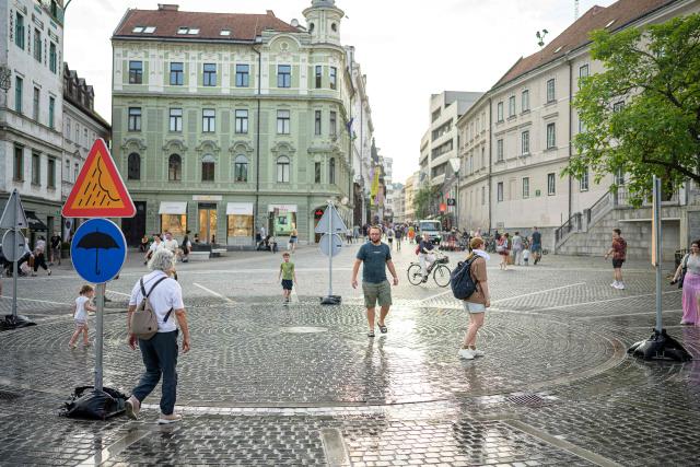 Pedestrians cool off at “The area with Ljubljana’s own weather” in Preseren Square in Ljubljana on June 24, 2026. Europe struggled to cope with a record-breaking heatwave on June 24, 2026, with at least 94 million people expected to experience temperatures above 35C, most of them in France and Spain. (Photo by Jure MAKOVEC / AFP)