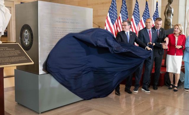 US Speaker of the House Mike Johnson and US House Minority Leader Hakeem Jeffries unveil the Semiquincentennial Congressional Time Capsule in honor of the 250th birthday of the United States to be opened on the 500th anniversary of the founding of the United States, during a ceremony in Emancipation Hall at the US Capitol in Washington, DC, on June 24, 2026. The capsule, that will be buried at the Independence National Historical Park in Philadelphia on July 4, features contributions from all 50 states, US territories and federal partners. Artifacts include state-specific mementos, student artwork, an Olympic gold medal, and a letter from living presidents. (Photo by SAUL LOEB / AFP)