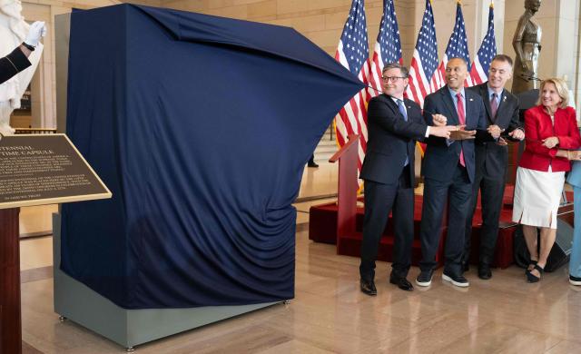 US Speaker of the House Mike Johnson and US House Minority Leader Hakeem Jeffries unveil the Semiquincentennial Congressional Time Capsule in honor of the 250th birthday of the United States to be opened on the 500th anniversary of the founding of the United States, during a ceremony in Emancipation Hall at the US Capitol in Washington, DC, on June 24, 2026. The capsule, that will be buried at the Independence National Historical Park in Philadelphia on July 4, features contributions from all 50 states, US territories and federal partners. Artifacts include state-specific mementos, student artwork, an Olympic gold medal, and a letter from living presidents. (Photo by SAUL LOEB / AFP)