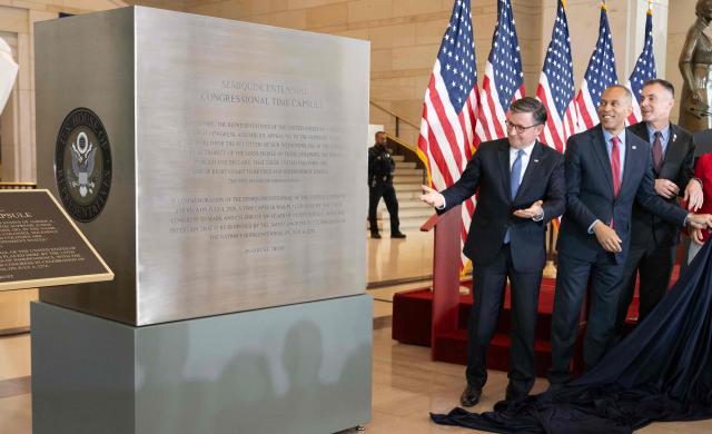 US Speaker of the House Mike Johnson and US House Minority Leader Hakeem Jeffries unveil the Semiquincentennial Congressional Time Capsule in honor of the 250th birthday of the United States to be opened on the 500th anniversary of the founding of the United States, during a ceremony in Emancipation Hall at the US Capitol in Washington, DC, on June 24, 2026. The capsule, that will be buried at the Independence National Historical Park in Philadelphia on July 4, features contributions from all 50 states, US territories and federal partners. Artifacts include state-specific mementos, student artwork, an Olympic gold medal, and a letter from living presidents. (Photo by SAUL LOEB / AFP)