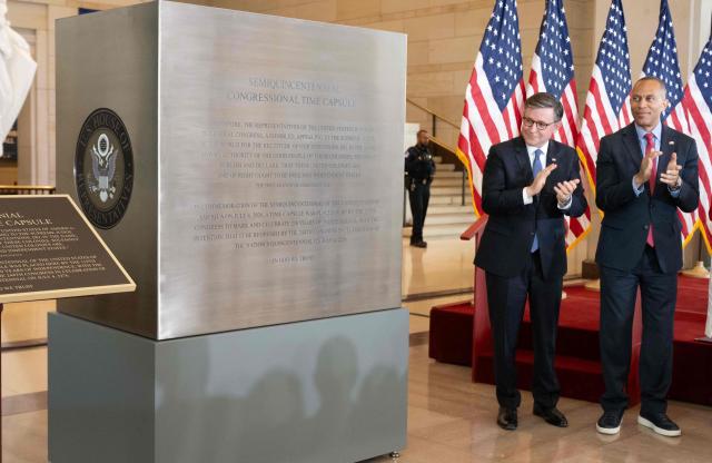 US Speaker of the House Mike Johnson and US House Minority Leader Hakeem Jeffries unveil the Semiquincentennial Congressional Time Capsule in honor of the 250th birthday of the United States to be opened on the 500th anniversary of the founding of the United States, during a ceremony in Emancipation Hall at the US Capitol in Washington, DC, on June 24, 2026. The capsule, that will be buried at the Independence National Historical Park in Philadelphia on July 4, features contributions from all 50 states, US territories and federal partners. Artifacts include state-specific mementos, student artwork, an Olympic gold medal, and a letter from living presidents. (Photo by SAUL LOEB / AFP)