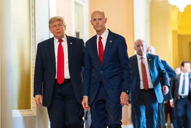 US President Donald Trump walks with Senator Rick Scott, Republican from Florida, after a lunch meeting with Senate Republicans at the US Capitol in Washington, DC, on June 24, 2026. President Trump said Wednesday he will refuse to sign a landmark housing bill, passed by Congress with broad bipartisan support, until lawmakers approve legislation that would overhaul American elections and restrict voter registration. (Photo by Aaron Schwartz / AFP)