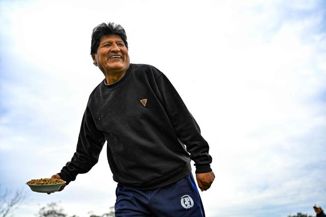 Former Bolivian president Evo Morales feeds fish at a fish pond on his private farm in Villa Victoria, Cochabamba Department, Bolivia, on June 24, 2026. Bolivia's former president Evo Morales said to AFP on June 23, 2026 that the Bolivian government is "forcing a civil war" with its "neoliberal policy," in an interview at his refuge in the jungle region of Chapare where he remains a fugitive. (Photo by MARTIN BERNETTI / AFP)