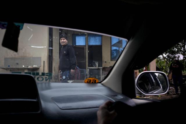 Former Bolivian president Evo Morales is seen from inside a vehicle on his private farm in Villa Victoria, Cochabamba Department, Bolivia, on June 24, 2026. Bolivia's former president Evo Morales said to AFP on June 23, 2026 that the Bolivian government is "forcing a civil war" with its "neoliberal policy," in an interview at his refuge in the jungle region of Chapare where he remains a fugitive. (Photo by MARTIN BERNETTI / AFP)