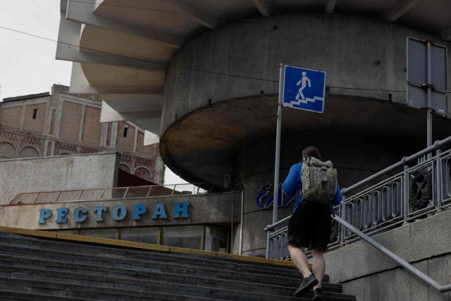 A pedestrian walks up the stairs in Kyiv on June 24, 2026, amid the Russian invasion of Ukraine. (Photo by Tetiana DZHAFAROVA / AFP)