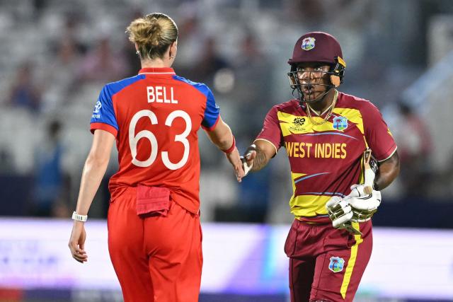 West Indies' Chinelle Henry (R) shakes hands with England's Lauren Bell (L) after the ICC Women's T20 cricket world cup 2026 match between England and West Indies, at Lord's in London on June 24, 2026. England won the game by 38 runs. (Photo by JUSTIN TALLIS / AFP)