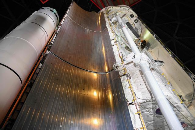 The Canadarm is displayed Inside the cargo bay of NASA’s Space Shuttle Endeavour stands stacked complete in a launch-ready vertical display with the ET-94 External Fuel Tank and a pair of Solid Rocket Boosters (SRBs) inside the Samuel Oschin Shuttle Gallery at the California Science Center in Los Angeles, on June 24, 2026. The Space Shuttle Endeavour exhibit will open on November 13, 2026 as part of a 200,000-square-foot expansion with the Samuel Oschin Air and Space Center. (Photo by Patrick T. Fallon / AFP)