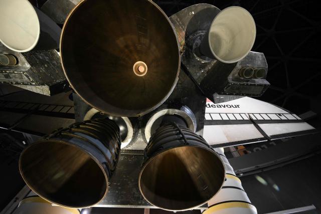 The engines of NASA’s Space Shuttle Endeavour as it stands stacked complete in a launch-ready vertical display with the ET-94 External Fuel Tank and a pair of Solid Rocket Boosters (SRBs) inside the Samuel Oschin Shuttle Gallery at the California Science Center in Los Angeles, California on June 24, 2026. The Space Shuttle Endeavour exhibit will open on November 13, 2026 as part of a 200,000-square-foot expansion with the Samuel Oschin Air and Space Center. (Photo by Patrick T. Fallon / AFP)