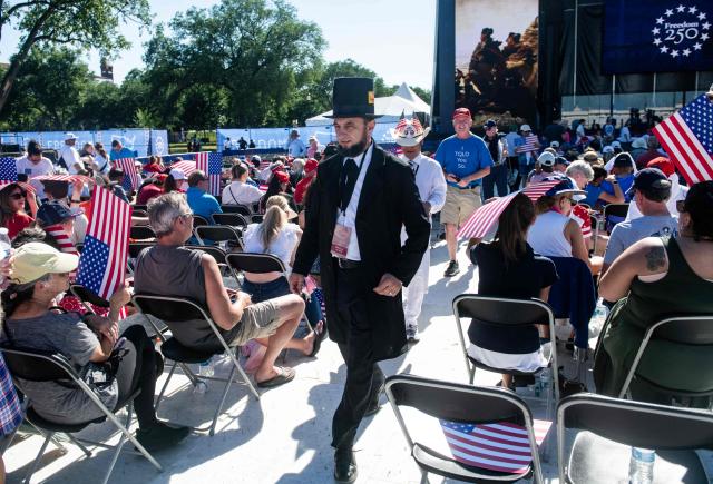 An attendee dressed as Abraham Lincoln walks through the crowd during a kick-off celebration for the "Great American State Fair" on the National Mall in Washington, DC, June 24, 2026. The "Great American State Fair" will be held from June 25 to July 10, 2026, to celebrate the 250th anniversary of US independence. (Photo by Matthew Hatcher / AFP)
