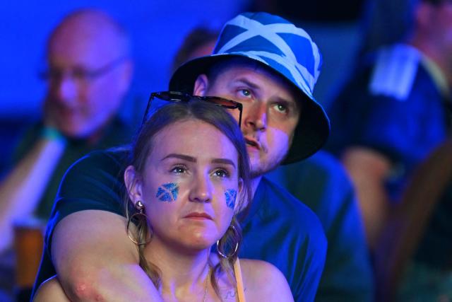 Scotland supporters react to their team going behind while watching the 2026 World Cup Group C football match between Scoland and Brazil, at the 4TheFans Fan Park at The Pitt in Edinburgh, Scotland on June 24, 2026. (Photo by ANDY BUCHANAN / AFP)