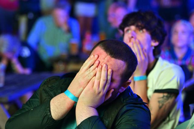 Scotland supporters react to their team going behind while watching the 2026 World Cup Group C football match between Scoland and Brazil, at the 4TheFans Fan Park at The Pitt in Edinburgh, Scotland on June 24, 2026. (Photo by ANDY BUCHANAN / AFP)