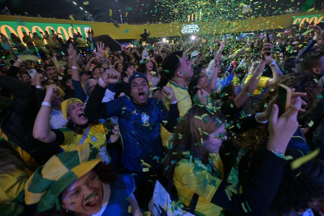 Brazilian fans react as they watch a live broadcast of the 2026 FIFA World Cup football match between Brazil and Scotland at Casa Caze TV in Sao Paulo, Brazil, on June 24, 2026. (Photo by NELSON ALMEIDA / AFP)
