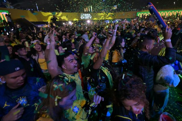 Brazilian fans react as they watch a live broadcast of the 2026 FIFA World Cup football match between Brazil and Scotland at Casa Caze TV in Sao Paulo, Brazil, on June 24, 2026. (Photo by NELSON ALMEIDA / AFP)