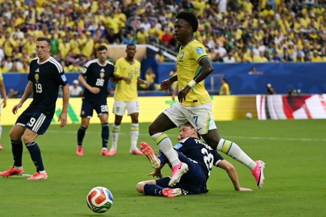 Brazil's forward #07 Vinicius Junior and Scotland's defender #22 Nathan Patterson fight for the ball during the 2026 World Cup Group C football match between Scotland and Brazil at the Miami Stadium in Miami Gardens on June 24, 2026.  (Photo by CHANDAN KHANNA / AFP)