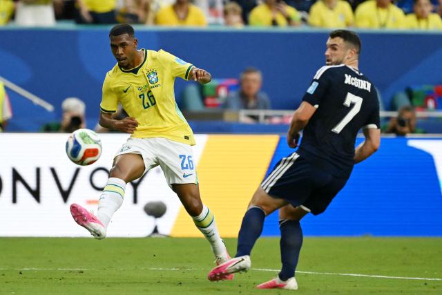 Brazil's forward #26 Rayan and Scotland's midfielder #07 John McGinn fight for the ball during the 2026 World Cup Group C football match between Scotland and Brazil at the Miami Stadium in Miami Gardens on June 24, 2026.  (Photo by CHANDAN KHANNA / AFP)