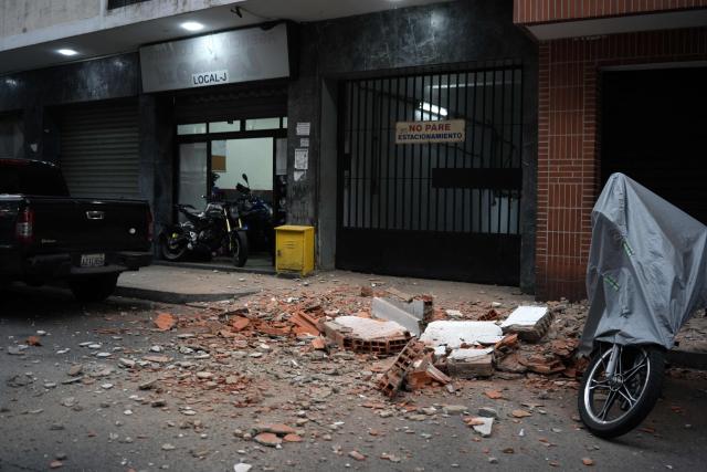 Debris lies on a street following an earthquake in Caracas on June 24, 2026. A magnitude 7.1 earthquake struck Venezuela on Wednesday, the United States Geological Survey (USGS) reported, triggering panic in Caracas, according to AFP journalists. The tremor, which was followed by several aftershocks, was also felt in Colombia. (Photo by Manaure QUINTERO / AFP)