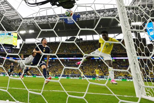Brazil's forward #07 Vinicius Junior (R) scores his team's second goal during the 2026 World Cup Group C football match between Scotland and Brazil at the Miami Stadium in Miami Gardens on June 24, 2026.  (Photo by CHANDAN KHANNA / AFP)