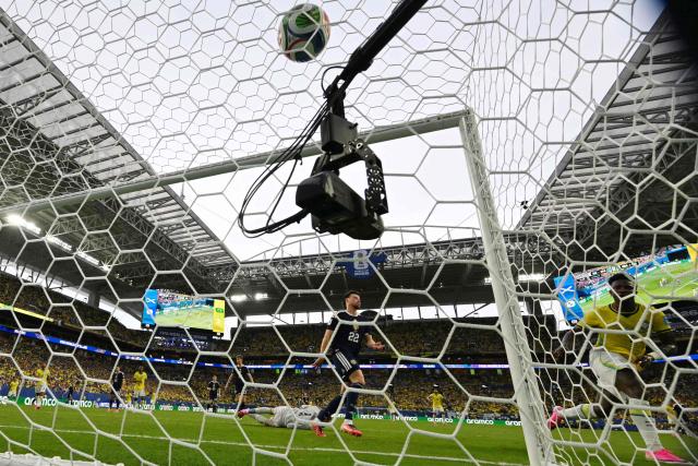 Brazil's forward #07 Vinicius Junior (R) scores his team's second goal during the 2026 World Cup Group C football match between Scotland and Brazil at the Miami Stadium in Miami Gardens on June 24, 2026.  (Photo by CHANDAN KHANNA / AFP)