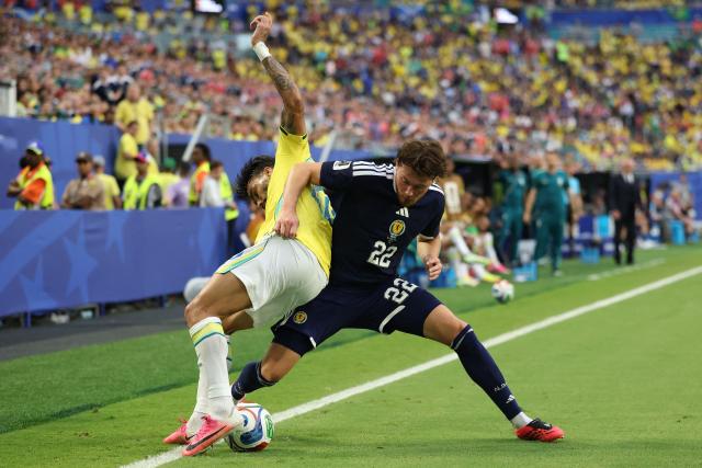 Brazil's midfielder #20 Lucas Paqueta and Scotland's defender #22 Nathan Patterson fight for the ball during the 2026 World Cup Group C football match between Scotland and Brazil at the Miami Stadium in Miami Gardens on June 24, 2026.  (Photo by PATRICIA DE MELO MOREIRA / AFP)