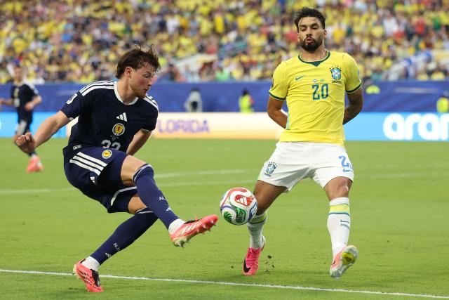 Brazil's midfielder #20 Lucas Paqueta and Scotland's defender #22 Nathan Patterson fight for the ball during the 2026 World Cup Group C football match between Scotland and Brazil at the Miami Stadium in Miami Gardens on June 24, 2026.  (Photo by PATRICIA DE MELO MOREIRA / AFP)