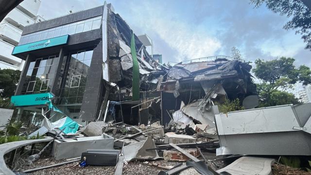 Picture of a Bancaribe building that collapsed after an earthquake in Caracas on June 24, 2026. A magnitude 7.1 earthquake struck Venezuela on Wednesday, the United States Geological Survey (USGS) reported, triggering panic in Caracas, according to AFP journalists. The tremor, which was followed by several aftershocks, was also felt in Colombia. (Photo by Juan BARRETO / AFP)
