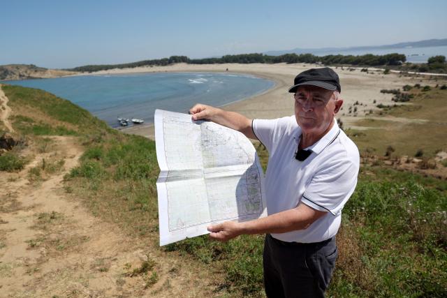 Minella Balliu, 68, one of the claimed landowners in Zvernec, shows an old map, near a beach in Zvernec, near Vlora on June 18, 2026. (Photo by Adnan Beci / AFP)