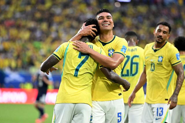 Brazil's forward #07 Vinicius Junior celebrates with teammate Brazil's midfielder #05 Casemiro scoring his team's second goal during the 2026 World Cup Group C football match between Scotland and Brazil at the Miami Stadium in Miami Gardens on June 24, 2026.  (Photo by CHANDAN KHANNA / AFP)