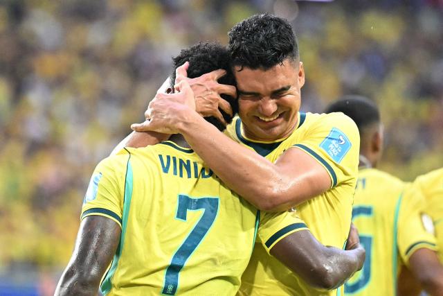 Brazil's forward #07 Vinicius Junior celebrates with teammate Brazil's midfielder #05 Casemiro scoring his team's second goal during the 2026 World Cup Group C football match between Scotland and Brazil at the Miami Stadium in Miami Gardens on June 24, 2026.  (Photo by CHANDAN KHANNA / AFP)