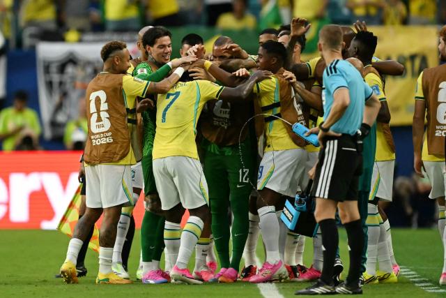 Brazil's forward #07 Vinicius Junior celebrates with teammates after scoring his team's second goal during the 2026 World Cup Group C football match between Scotland and Brazil at the Miami Stadium in Miami Gardens on June 24, 2026.  (Photo by CHANDAN KHANNA / AFP)
