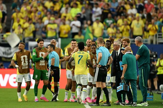 Brazil's forward #07 Vinicius Junior celebrates with teammates after scoring his team's second goal during the 2026 World Cup Group C football match between Scotland and Brazil at the Miami Stadium in Miami Gardens on June 24, 2026.  (Photo by CHANDAN KHANNA / AFP)