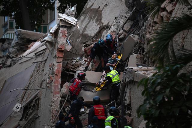 Rescue workers carry a person on a stretcher out of a collapsed building following an earthquake in Caracas on June 24, 2026. A magnitude 7.1 earthquake struck Venezuela on Wednesday, the United States Geological Survey (USGS) reported, triggering panic in Caracas, according to AFP journalists. The tremor, which was followed by several aftershocks, was also felt in Colombia. (Photo by Juan BARRETO / AFP)