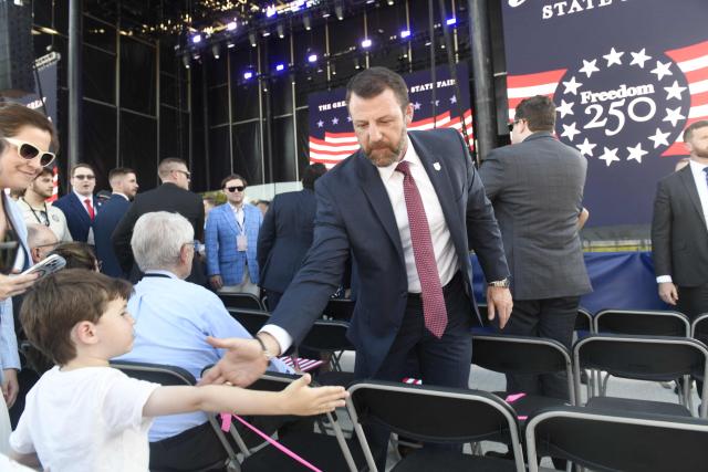 US Secretary of Homeland Security Markwayne Mullin shakes hands with a young attendee during a kick-off celebration for the "Great American State Fair" on the National Mall in Washington, DC, June 24, 2026. The "Great American State Fair" will be held from June 25 to July 10, 2026, to celebrate the 250th anniversary of US independence. (Photo by Matthew Hatcher / AFP)