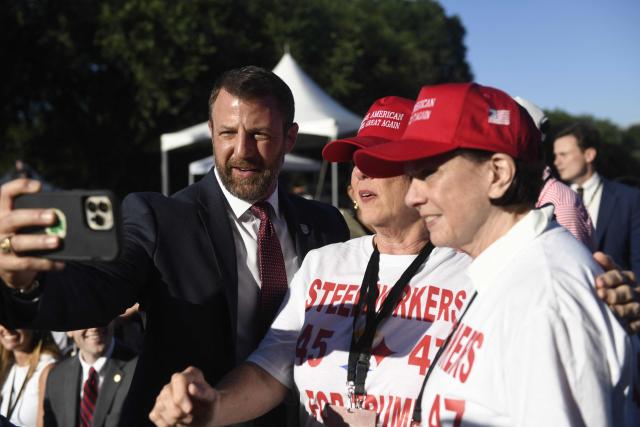 US Secretary of Homeland Security Markwayne Mullin takes a photo with attendees during a kick-off celebration for the "Great American State Fair" on the National Mall in Washington, DC, June 24, 2026. The "Great American State Fair" will be held from June 25 to July 10, 2026, to celebrate the 250th anniversary of US independence. (Photo by Matthew Hatcher / AFP)