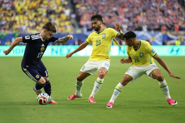 Scotland's forward #17 Ben Gannon-Doak, Brazil's midfielder #20 Lucas Paqueta and defender #16 Douglas Santos fight for the ball during the 2026 World Cup Group C football match between Scotland and Brazil at the Miami Stadium in Miami Gardens on June 24, 2026.  (Photo by PATRICIA DE MELO MOREIRA / AFP)