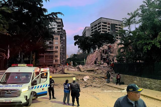 Rescuers search for victims in a collapsed building following an earthquake in Caracas on June 24, 2026. A magnitude 7.1 earthquake struck Venezuela on Wednesday, the United States Geological Survey (USGS) reported, triggering panic in Caracas, according to AFP journalists. The tremor, which was followed by several aftershocks, was also felt in Colombia. (Photo by Manaure QUINTERO / AFP)