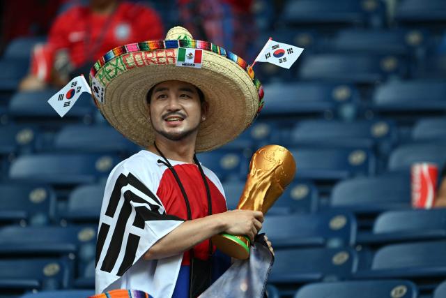 A South Korean fan arrives to watch the 2026 World Cup Group A football match between South Africa and South Korea at the Monterrey Stadium in Guadalupe, Mexico, on June 24, 2026.  (Photo by Yuri CORTEZ / AFP)