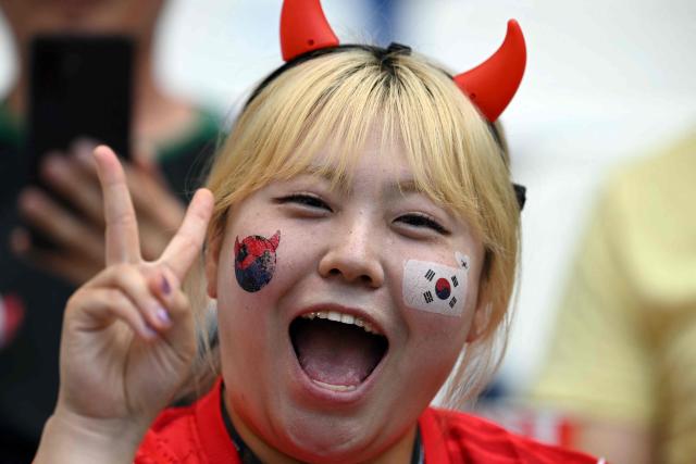 A South Korean fan cheers as she waits for the start of the 2026 World Cup Group A football match between South Africa and South Korea at the Monterrey Stadium in Guadalupe, Mexico, on June 24, 2026.  (Photo by Yuri CORTEZ / AFP)
