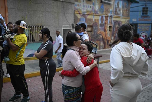 A woman comforts a child in the street following an earthquake in Caracas on June 24, 2026. A magnitude 7.1 earthquake struck Venezuela on Wednesday, the United States Geological Survey (USGS) reported, triggering panic in Caracas, according to AFP journalists. The tremor, which was followed by several aftershocks, was also felt in Colombia. (Photo by Federico PARRA / AFP)
