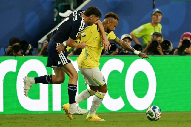 Scotland's forward #11 Ryan Christie and Brazil's forward #10 Neymar fight for the ball during the 2026 World Cup Group C football match between Scotland and Brazil at the Miami Stadium in Miami Gardens on June 24, 2026.  (Photo by CHANDAN KHANNA / AFP)