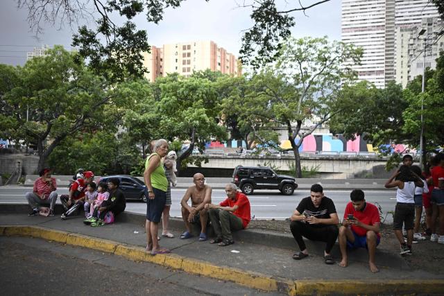 People remain in the street after an earthquake in Caracas on June 24, 2026. A magnitude 7.1 earthquake struck Venezuela on Wednesday, the United States Geological Survey (USGS) reported, triggering panic in Caracas, according to AFP journalists. The tremor, which was followed by several aftershocks, was also felt in Colombia. (Photo by Federico PARRA / AFP)