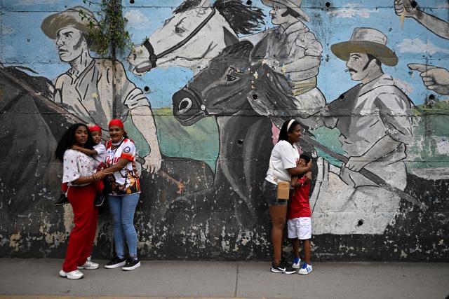 Women and child react in the street following an earthquake in Caracas on June 24, 2026. A magnitude 7.1 earthquake struck Venezuela on Wednesday, the United States Geological Survey (USGS) reported, triggering panic in Caracas, according to AFP journalists. The tremor, which was followed by several aftershocks, was also felt in Colombia. (Photo by Federico PARRA / AFP)