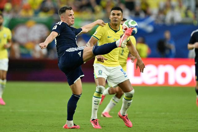 Scotland's forward #20 Lawrence Shankland and Brazil's midfielder #05 Casemiro fight for the ball during the 2026 World Cup Group C football match between Scotland and Brazil at the Miami Stadium in Miami Gardens on June 24, 2026.  (Photo by CHANDAN KHANNA / AFP)
