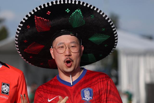 A South Korean fan, wearing a Mexican charro hat, arrives to watch the 2026 World Cup Group A football match between South Africa and South Korea at the Monterrey Stadium in Guadalupe, Mexico, on June 24, 2026.  (Photo by Julio Cesar AGUILAR / AFP)