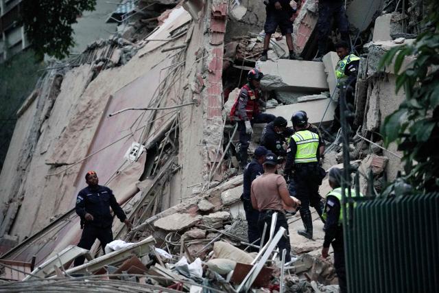 Rescuers search for victims in a collapsed building following an earthquake in Caracas on June 24, 2026. A magnitude 7.1 earthquake struck Venezuela on Wednesday, the United States Geological Survey (USGS) reported, triggering panic in Caracas, according to AFP journalists. The tremor, which was followed by several aftershocks, was also felt in Colombia. (Photo by Manaure Quintero / AFP)