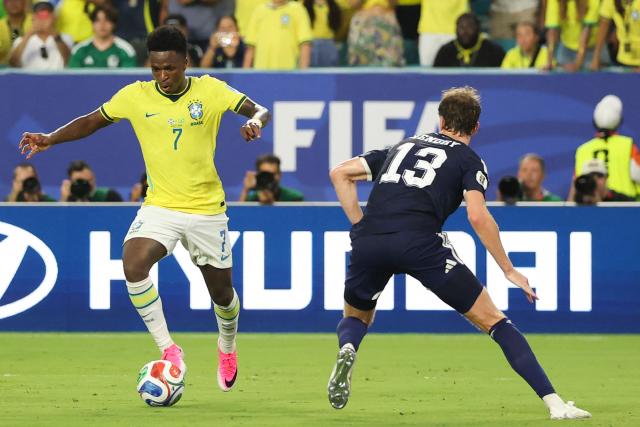 Brazil's forward #07 Vinicius Junior and Scotland's defender #13 Jack Hendry fight for the ball during the 2026 World Cup Group C football match between Scotland and Brazil at the Miami Stadium in Miami Gardens on June 24, 2026.  (Photo by PATRICIA DE MELO MOREIRA / AFP)