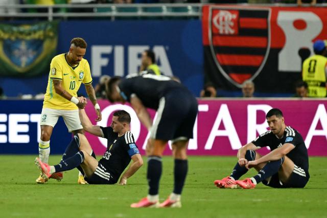 Brazil's forward #10 Neymar helps Scotland's midfielder #23 Kenny McLean at the end of the 2026 World Cup Group C football match between Scotland and Brazil at the Miami Stadium in Miami Gardens on June 24, 2026.  (Photo by CHANDAN KHANNA / AFP)